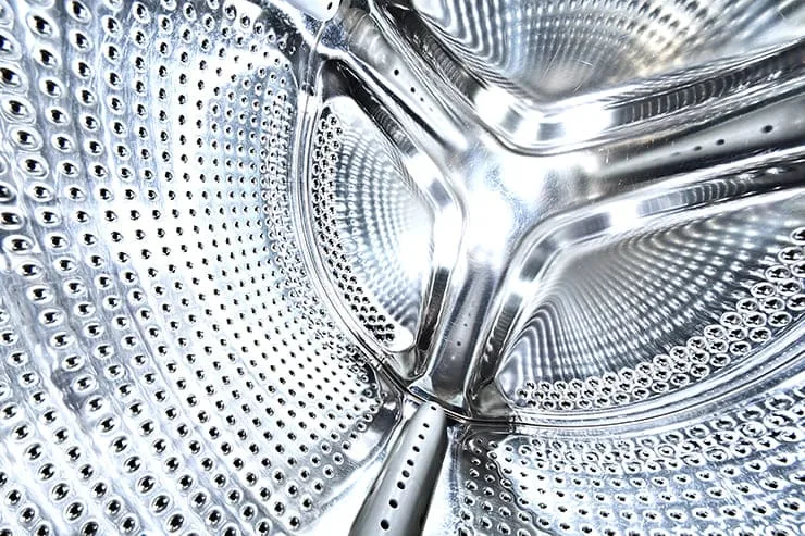 A silver washing machine with a stainless steel door.